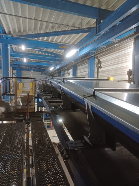 Conveyor protection for biomass transfer to boiler